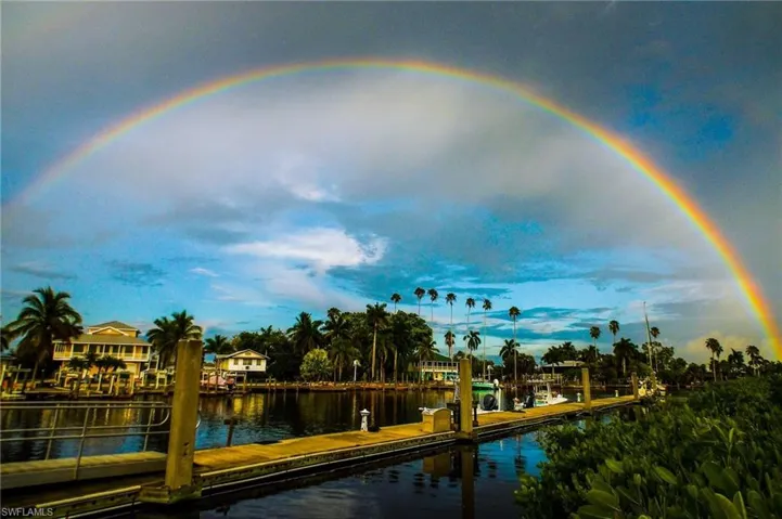 Dock area with a water view & rainbow