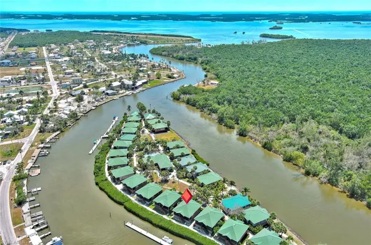 Birds eye view of property with a view of trees, a residential view, and a water view