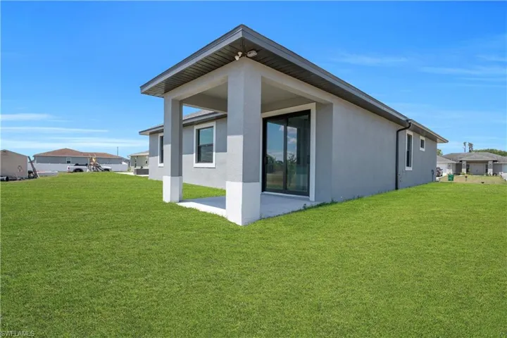 Expansive green lawn bordering the rear of the property
