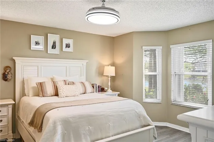Bedroom featuring a textured ceiling and wood finished floors