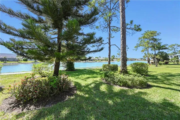 View of green lawn featuring a water view