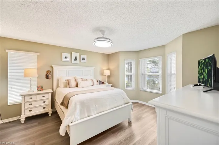 Bedroom featuring light wood-style floors and a textured ceiling