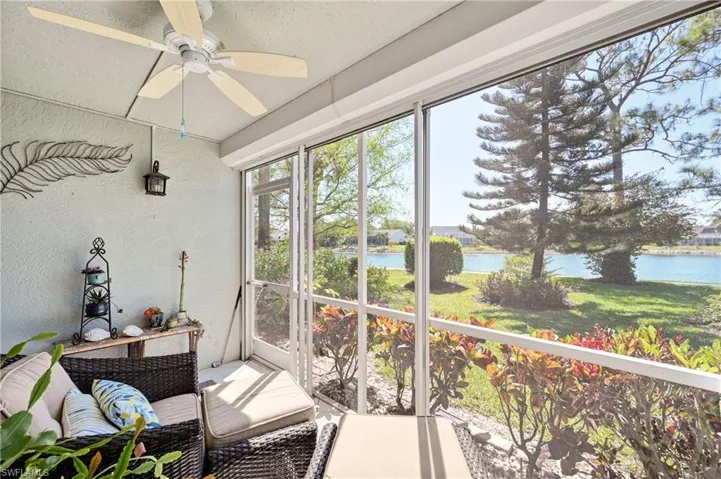 Sunroom / solarium featuring a water view and ceiling fan