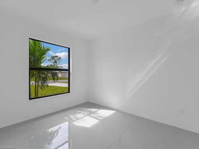 Spare room featuring marble look tile flooring