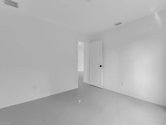 Empty room with baseboards and light marble finish floors