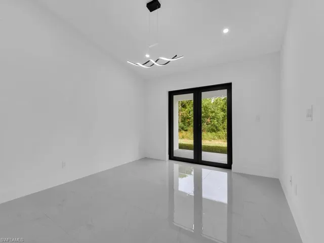 Spare room with light marble finish floors and recessed lighting