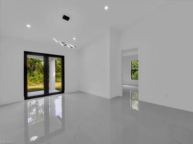 Spare room with light marble finish floors and recessed lighting