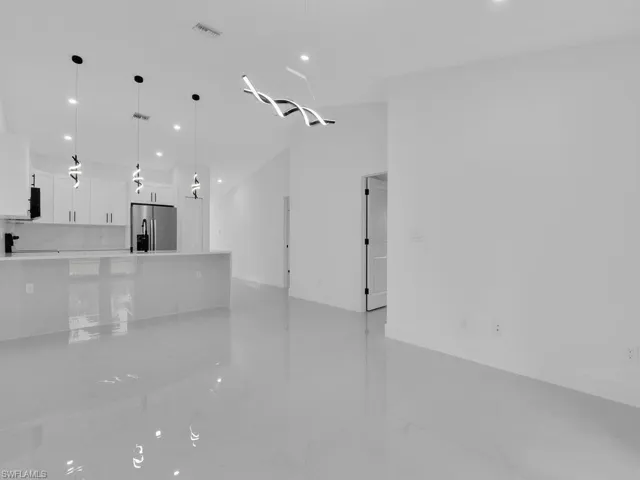 Unfurnished living room featuring recessed lighting and light marble finish floors