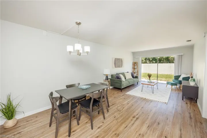 Dining space featuring light hardwood / wood-style flooring and a notable chandelier