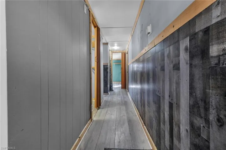 Corridor featuring hardwood / wood-style flooring