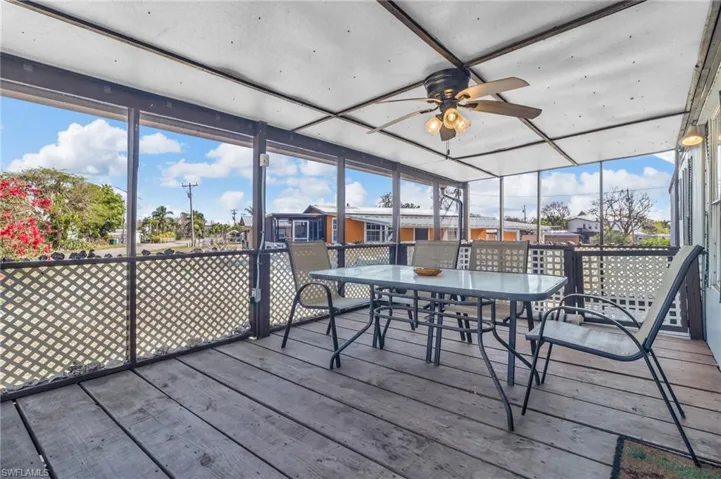 Patio / featuring a wealth of natural light, a ceiling fan, and outdoor dining space