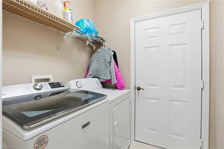 Laundry area featuring washing machine and clothes dryer
