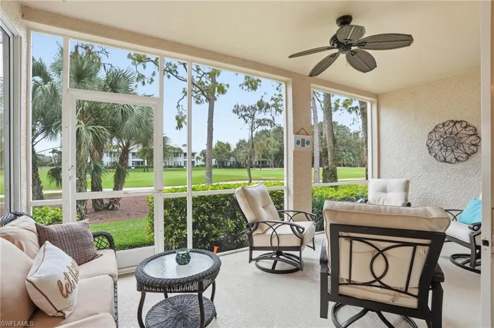 Sunroom / solarium featuring ceiling fan, view of golf course, and an outdoor living space