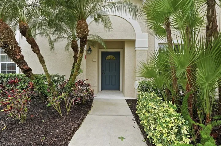 View of exterior entry with stucco siding
