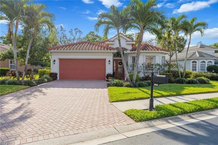 Mediterranean / spanish home featuring decorative driveway, an attached garage, a tile roof, and stucco siding