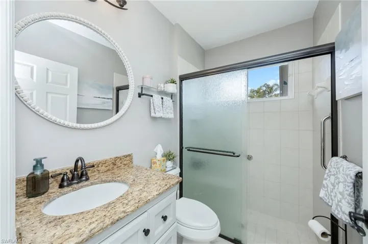 Full bath featuring vanity and a shower stall