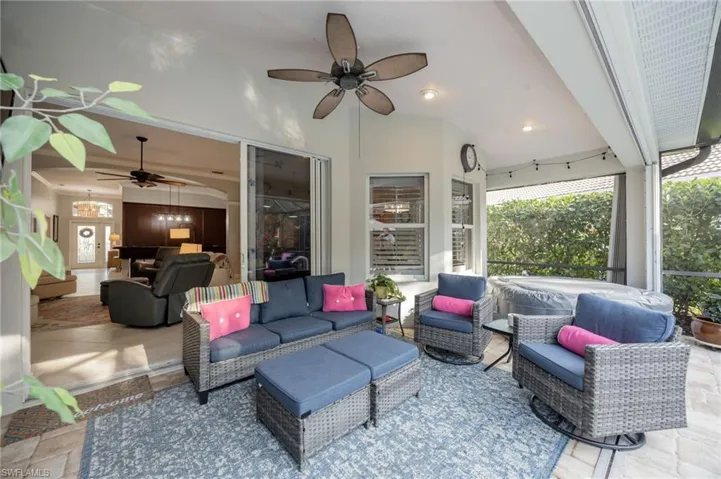 View of patio with ceiling fan and outdoor seating