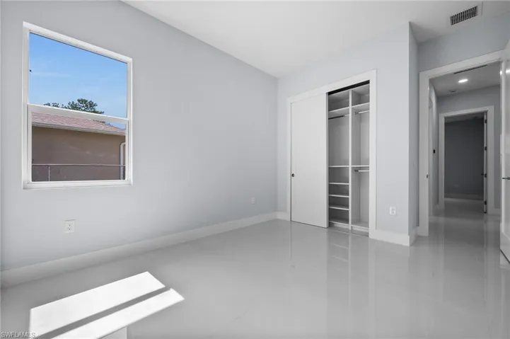 Unfurnished bedroom with tile patterned flooring and a closet