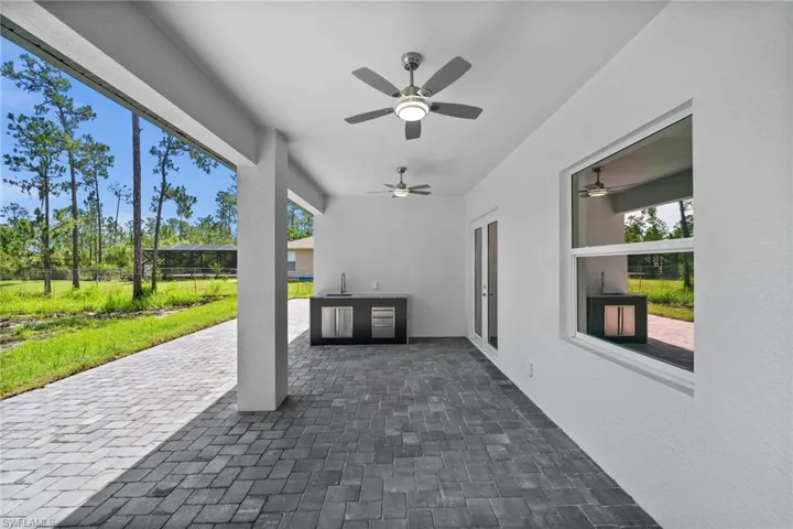 View of patio featuring an outdoor kitchen and a ceiling fan