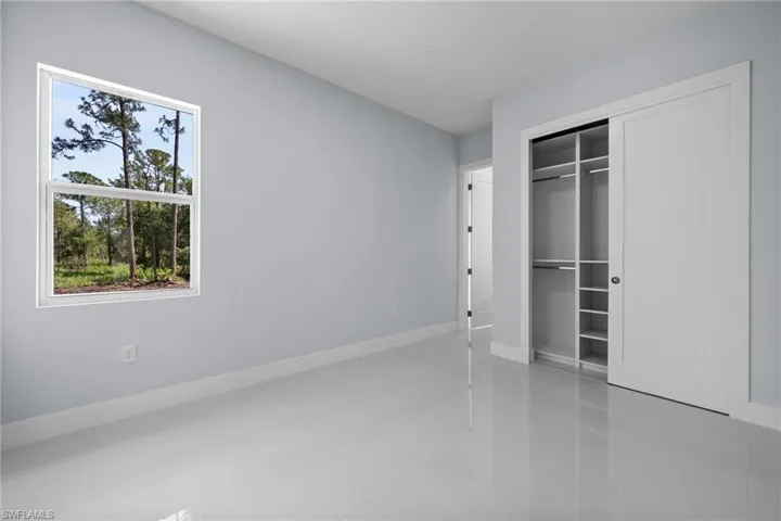 Unfurnished bedroom with a closet and baseboards