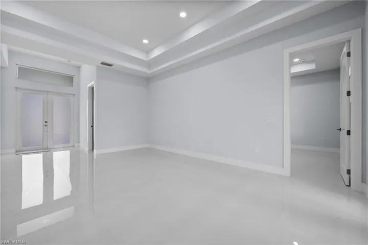 Spare room featuring french doors, recessed lighting, and tile patterned floors