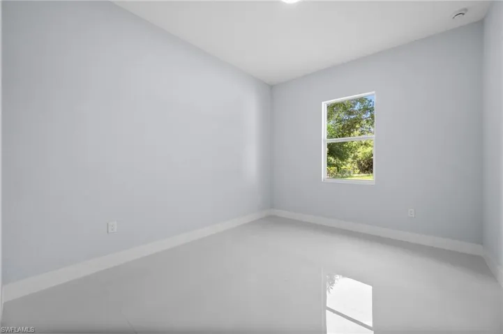 Unfurnished room with a smoke detector and light tile patterned floors