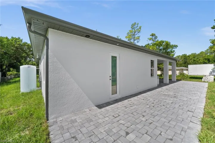 Back of property with stucco siding and a patio