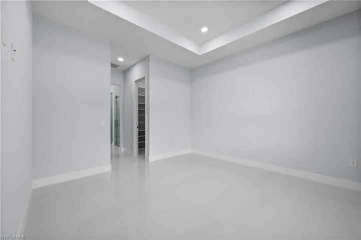 Empty room featuring recessed lighting and tile patterned floors