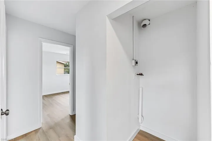 Hall featuring light wood-type flooring
