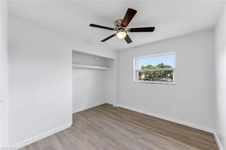 Unfurnished room featuring ceiling fan and hardwood / wood-style flooring