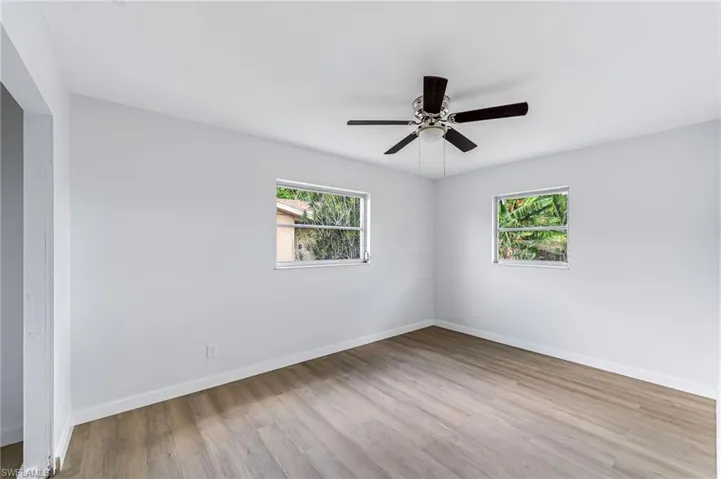 Unfurnished room featuring ceiling fan and hardwood / wood-style flooring