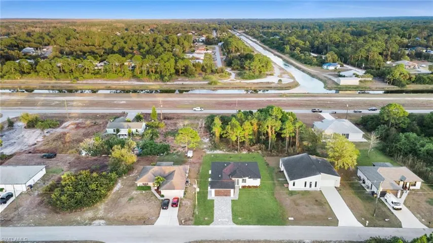 Aerial view of residential area featuring a forest