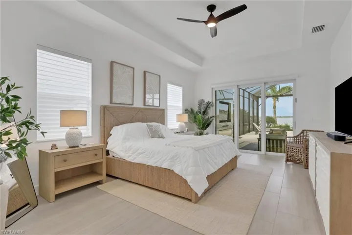 Spacious room with tray ceiling and recessed lighting