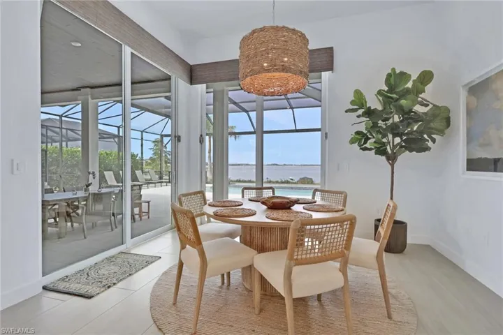 Dining area featuring a woven pendant light fixture and white walls