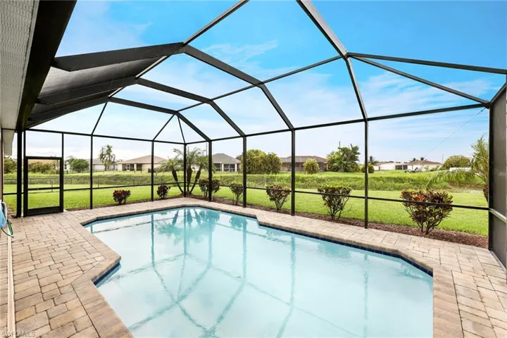 View of swimming pool with a patio, a lawn, and a lanai