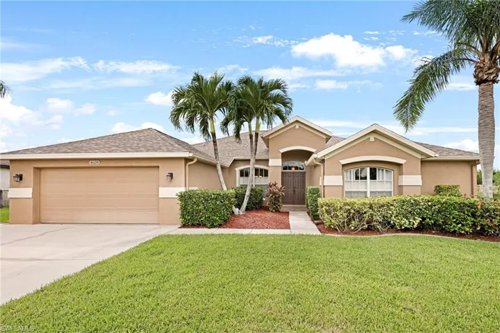 Ranch-style home with a garage and a front yard
