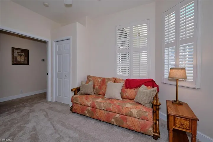 Sitting room featuring carpet flooring and ceiling fan