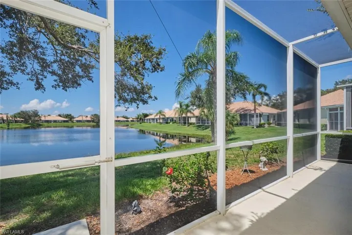 Unfurnished sunroom with a residential view and a water view