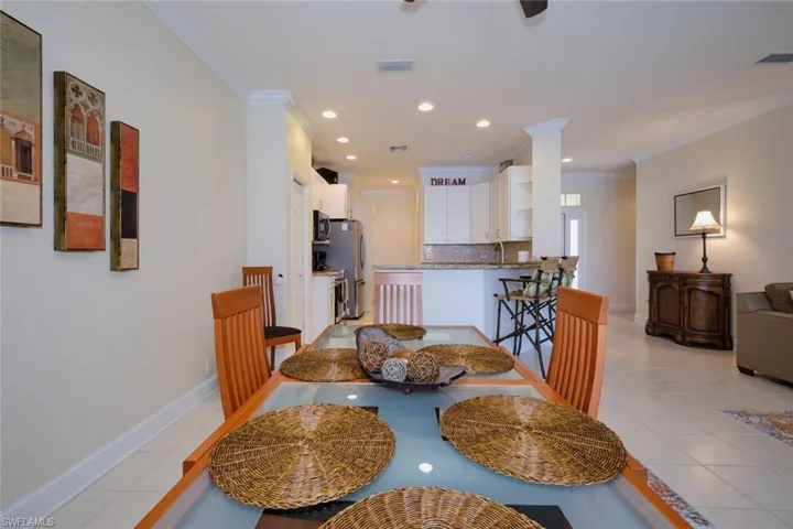 Dining area featuring ornamental molding, light tile patterned floors, and recessed lighting