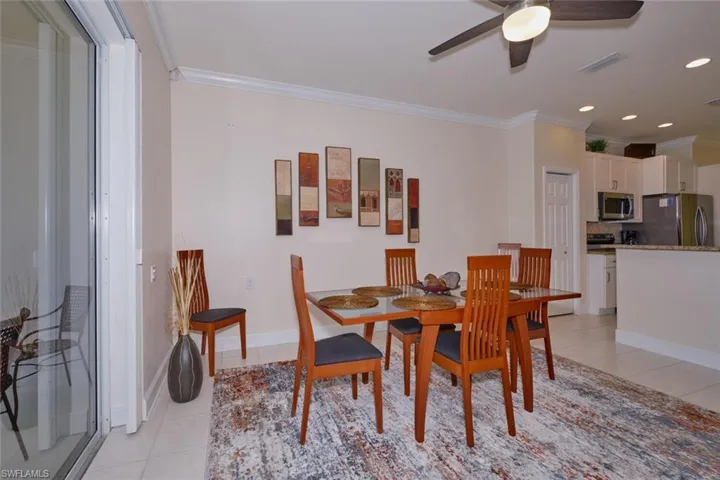 Dining room featuring crown molding, a ceiling fan, light tile patterned flooring, and recessed lighting