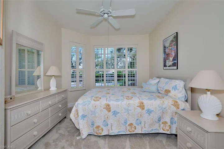 Bedroom featuring light carpet and ceiling fan