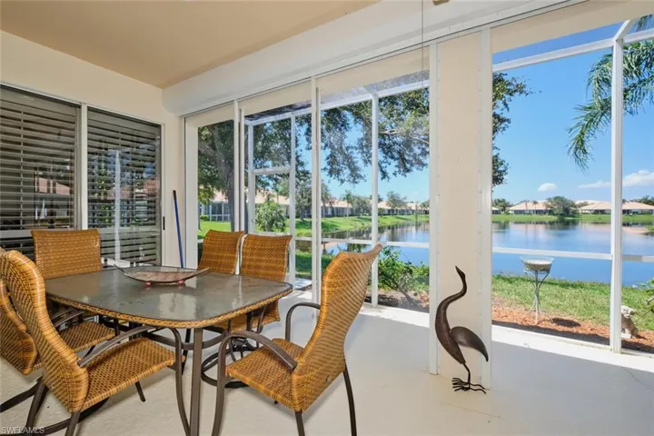 Sunroom / solarium with a water view and a residential view