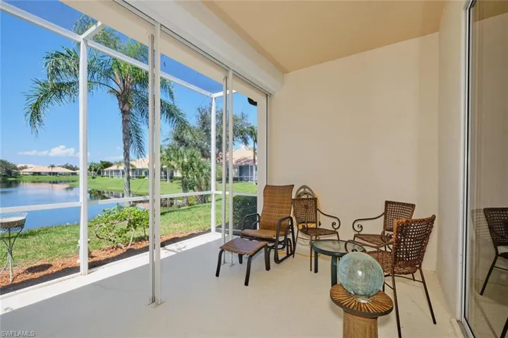 Sunroom / solarium featuring a water view and a residential view