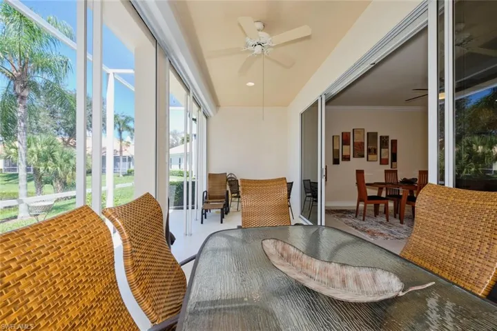 Sunroom with ceiling fan and outdoor dining space