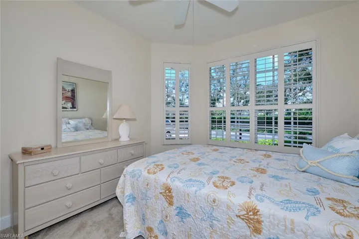 Bedroom with light carpet and ceiling fan