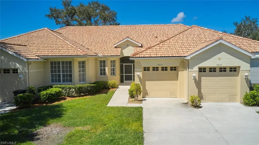 Mediterranean / spanish house featuring driveway, a garage, stucco siding, and a front yard