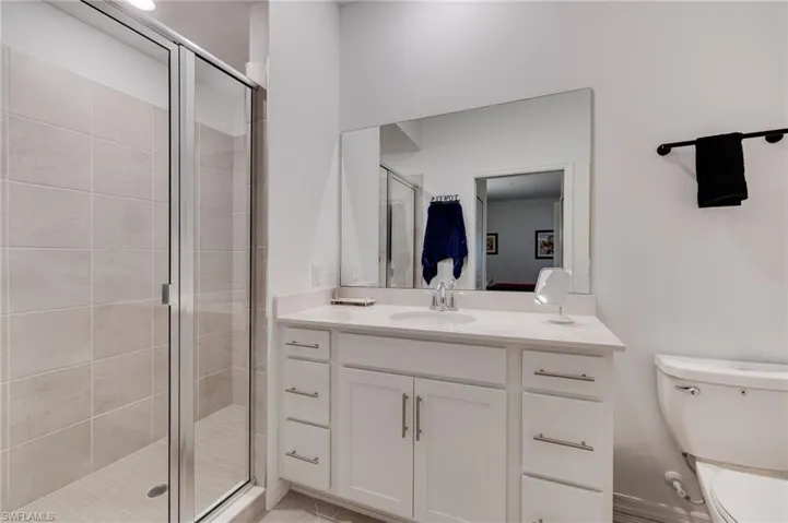 Full bathroom featuring a stall shower and vanity