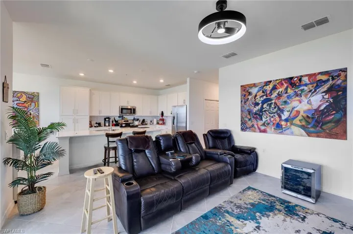 Living room featuring recessed lighting, light tile patterned floors, and ceiling fan