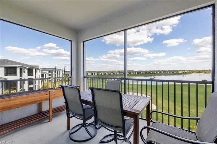 Sunroom / solarium with a water view and a residential view