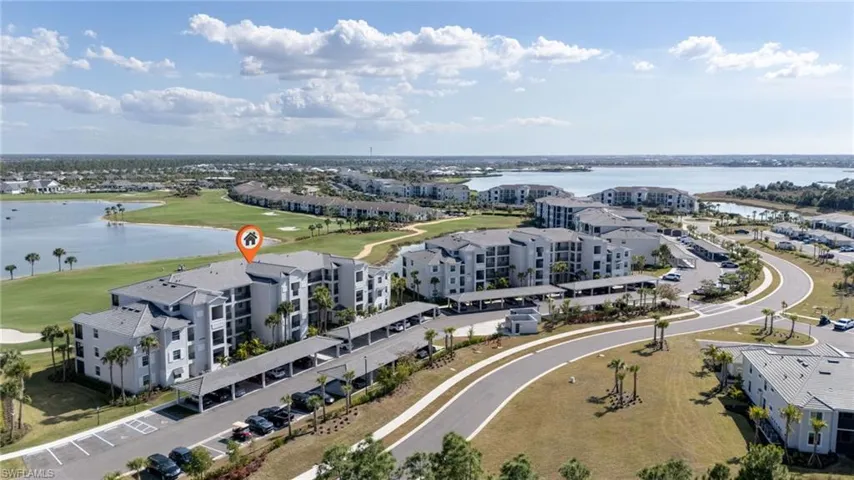 Bird's eye view of apartment complex and a nearby body of water